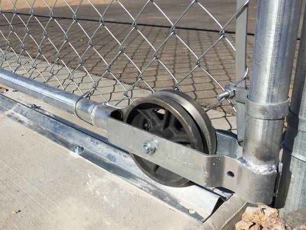 wheels and tracks of chain link fence rolling gate